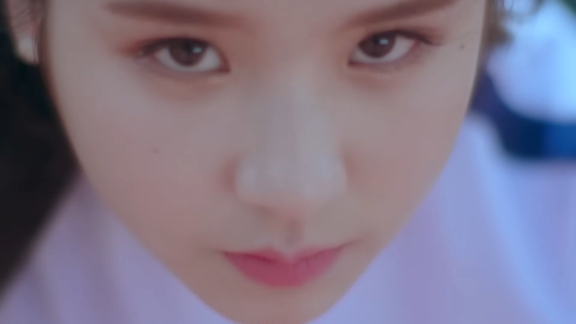 Heejin staring up at the viewer.
